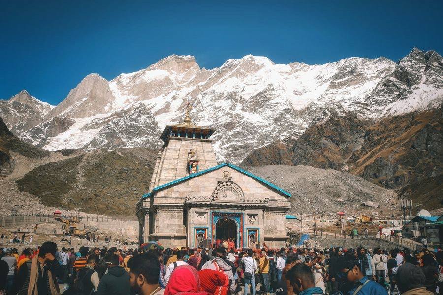 Pilgrims gathered at Kedarnath temple beneath snow-capped Himalayan peaks