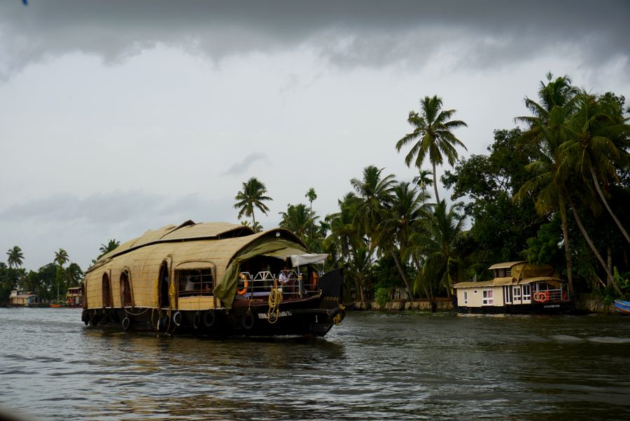 A traditional Kerala houseboat cruising the palm-lined backwaters