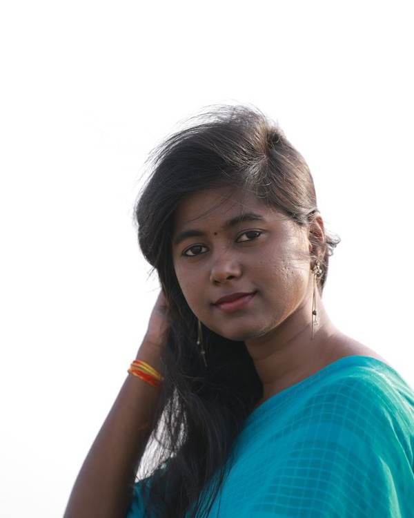 Smiling young Indian woman in a turquoise top