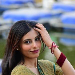 Smiling young Indian woman in a green saree
