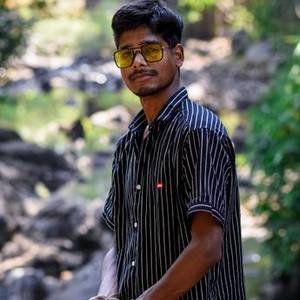 Young Indian man in sunglasses and a striped shirt