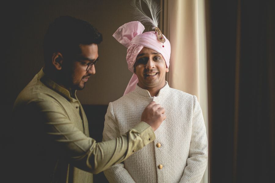 A groom-to-be receiving precision grooming before his wedding