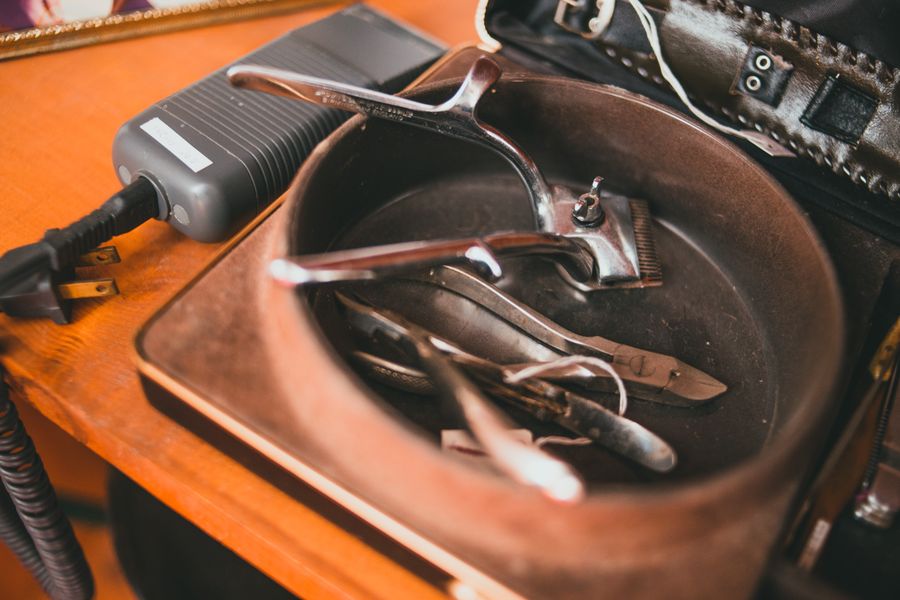 Vintage barber tools laid out on a wooden table