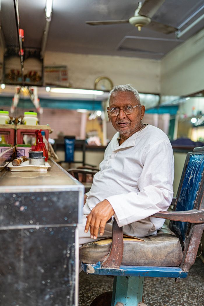 Jaswinder Singh Chhabra, owner and head barber, seated in the shop