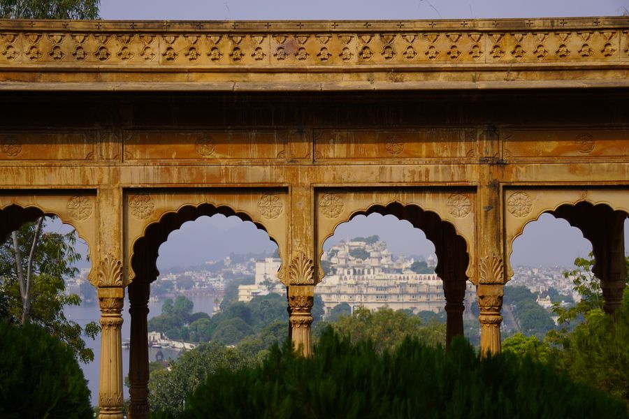 Udaipur City Palace seen through an ornate heritage archway