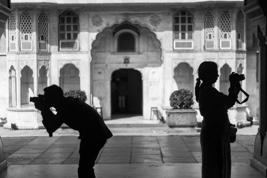 Photographers at work in a historic Jaipur courtyard